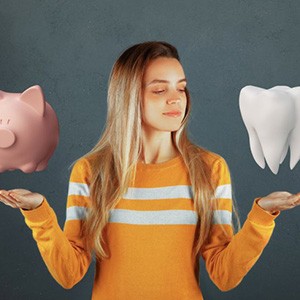 Woman holding a piggy bank in one hand and giant tooth in the other