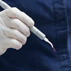 Dentist holding a laser