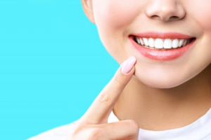 Close up of woman pointing to her teeth